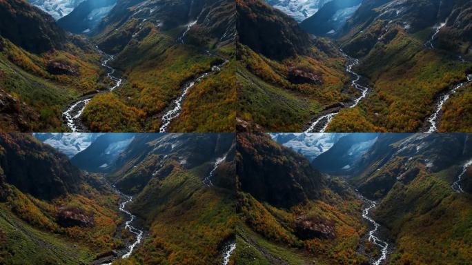 风景如画的航拍，在秋天的山上融化的冰川，在山谷中流动的河流