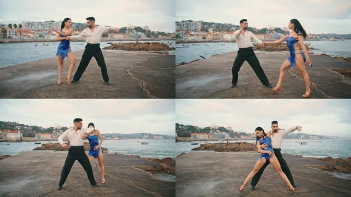 情侣跳探戈海岸阴天。热辣的表演者在练习拉丁舞蹈。