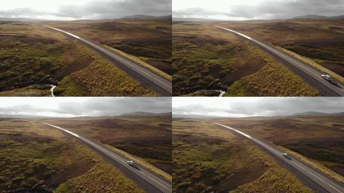 冰岛，日落时分，一辆白色轿车行驶在宽阔的道路上。