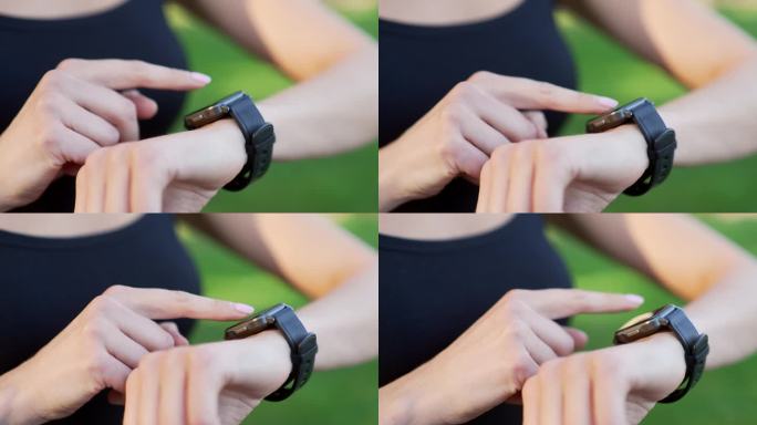 一个戴着智能手表的女性的手特写。女运动员使用健身追踪器，在触摸屏上滚动手指，