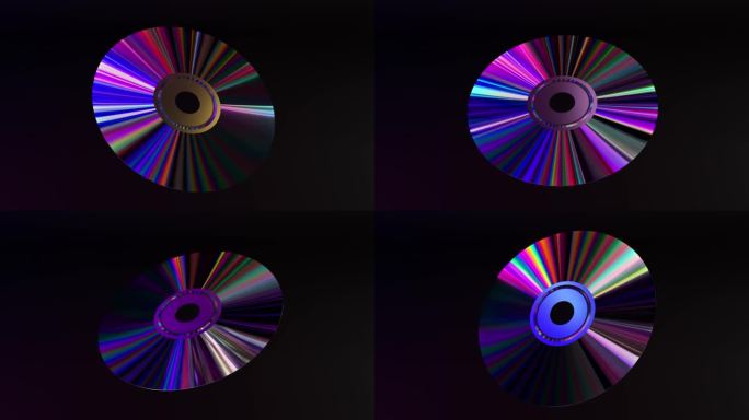 抽象的概念。CD DVD在黑色背景上旋转。彩虹。蓝色霓虹色。三维动画