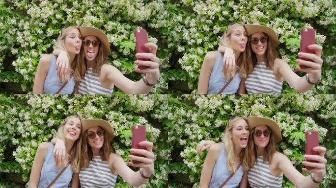 最好的朋友在度假用智能手机自拍女孩用手机分享照片鲜花墙发送信息享受夏天意大利欧洲度假旅行冒险