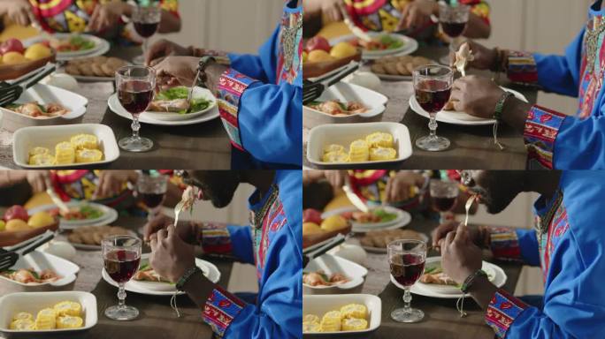 非裔美国人身穿达什基和库菲在宽扎节吃节日大餐