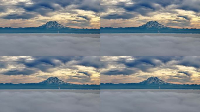 美国华盛顿，雷尼尔山阴云密布的日落美景。前景中的云海。广角镜头