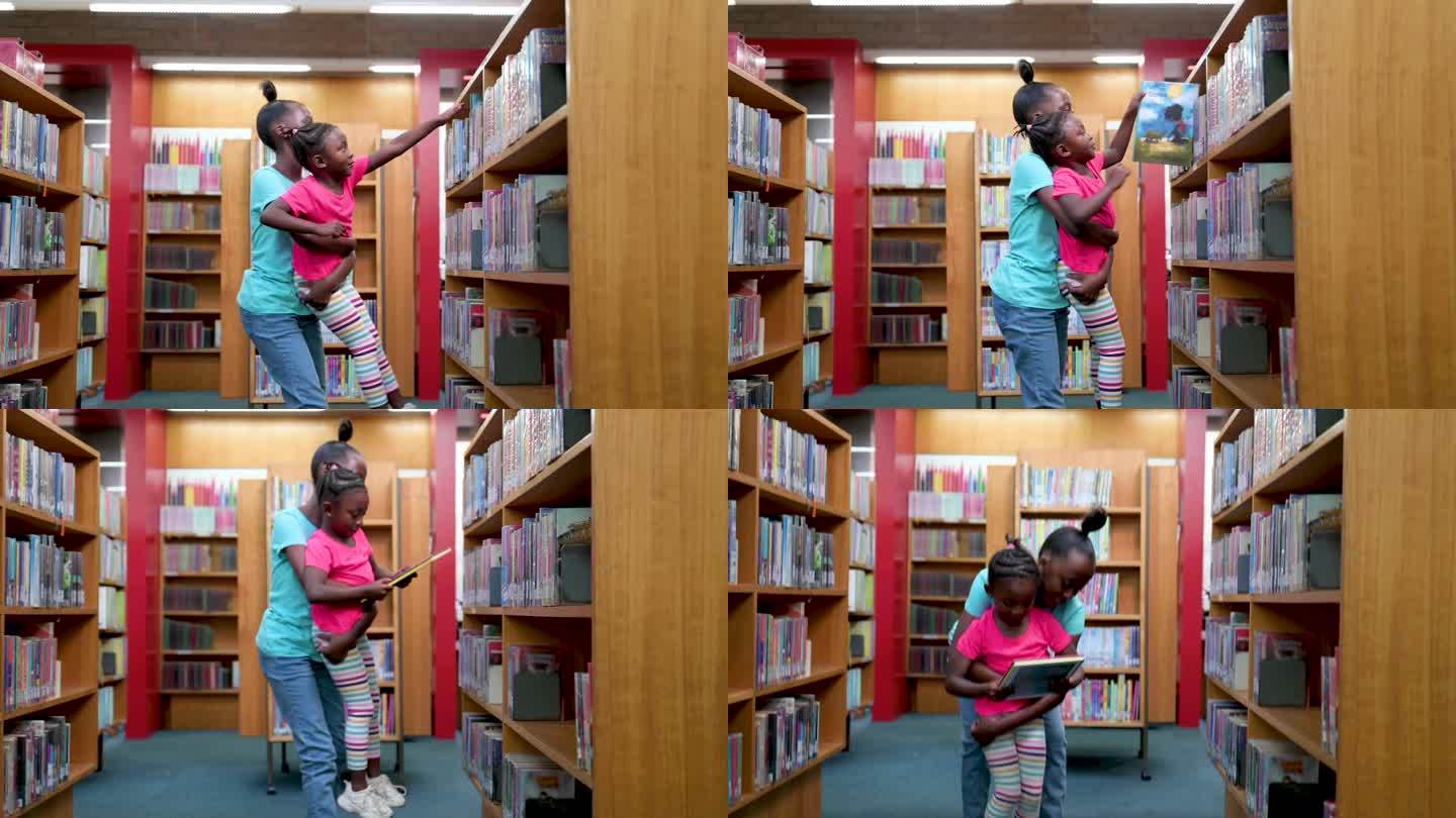 少年帮助小女孩伸手去拿图书馆书架上的书