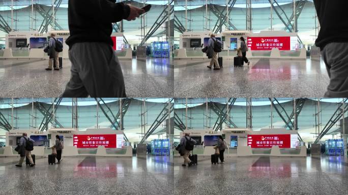 旅客推行李箱在机场候机楼通道匆匆走过