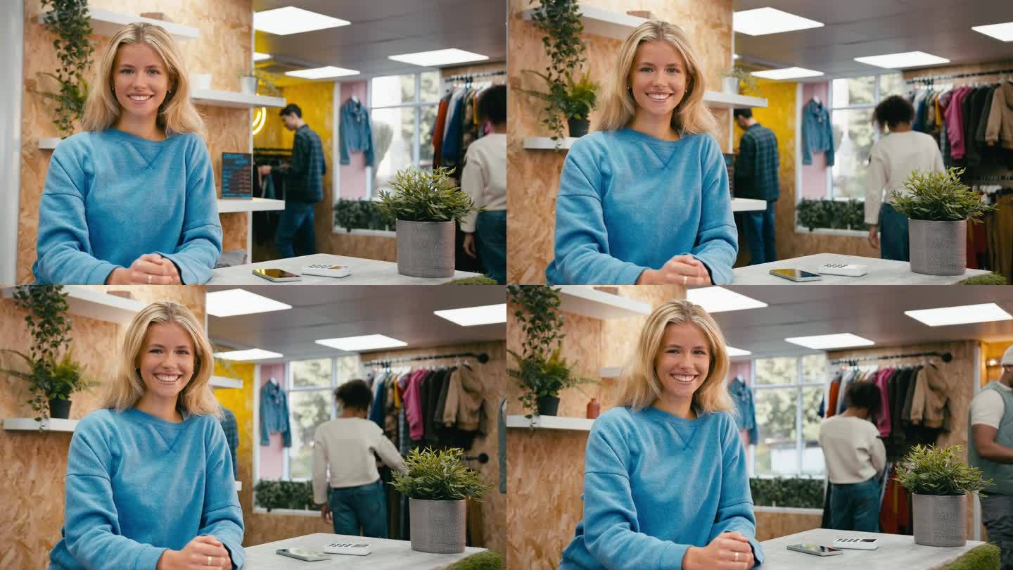 在流行时尚或服装店的收银台微笑的女性销售助理的肖像