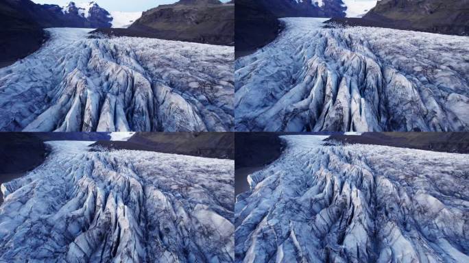 航拍:冰川蜿蜒的路径上有深深的裂缝和锯齿状的冰层，这是气候变化对这个自然奇观不断移动和转变的影响的证