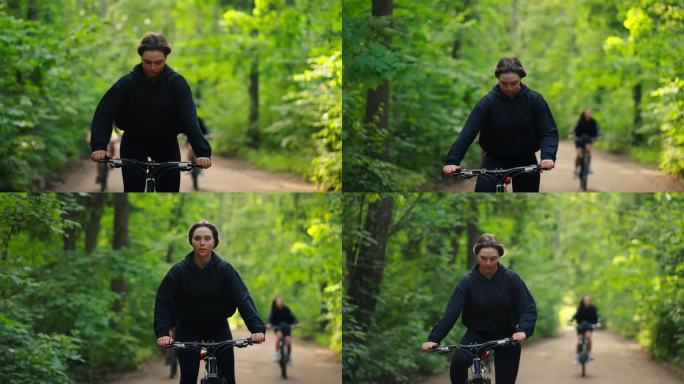 年轻女性骑自行车在大自然的肖像，正面视图，慢动作，骑自行车在大自然