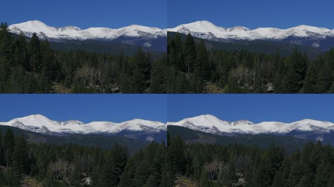 电影空中无人机放大在丹佛山的第一场雪蓝天埃文斯峰初秋秋天美丽的蓝鸟晴朗的早晨日出天科罗拉多落基山脉的