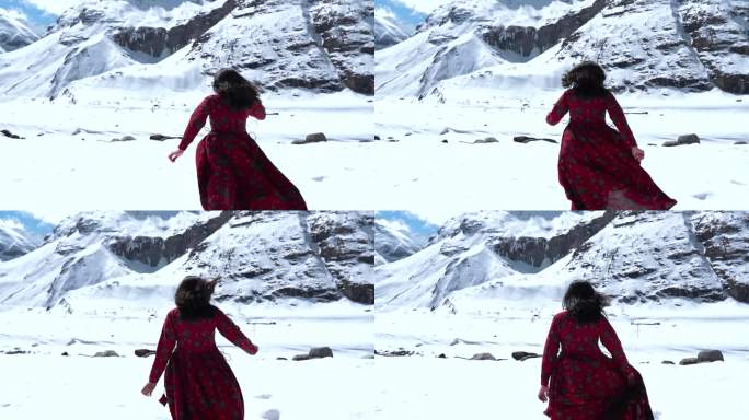 穿着红色长袍的年轻印度女子在冬天的山间奔跑。快乐的女人享受大自然的背影。户外可爱女性的跟踪镜头。印度