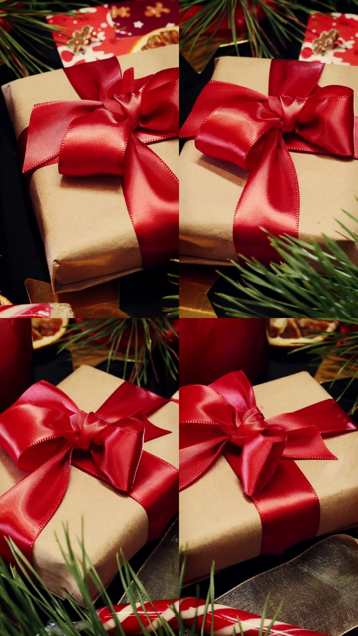 圣诞礼品盒配红丝带，衬托圣诞装饰。垂直视频