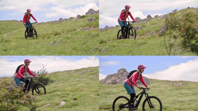 一名女子在山顶上骑着她的电动山地车