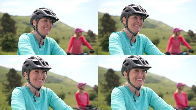 美丽的女山地自行车手坐在她的电动自行车和微笑