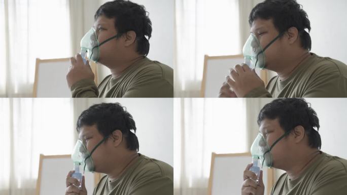 一名亚洲男子在卧室里用雾化器治疗哮喘