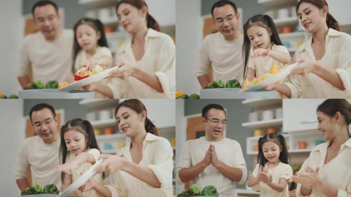 快乐的亚洲家庭在快乐厨房一起烹饪:父母教孩子制作新鲜蔬菜沙拉的艺术。