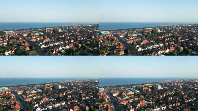 航拍视频捕捉斯凯格内斯，林肯郡的沿海魅力，展示其繁华的旅游小镇，广阔的海滩，和标志性的码头在一个夏天