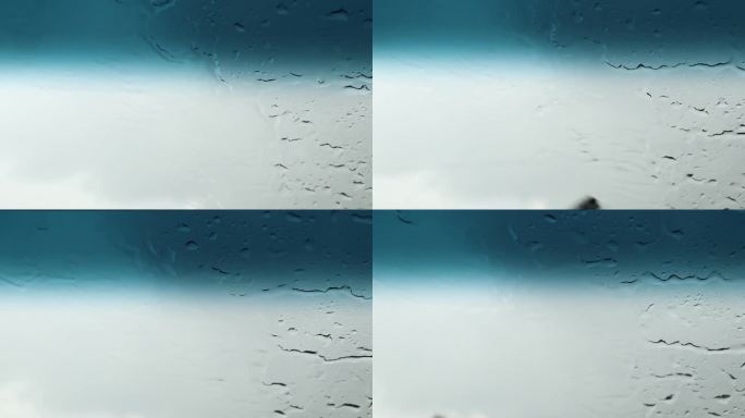 夏日，乌克兰，一辆汽车上的雨刷擦去一辆高速行驶的汽车上的雨水，从车内俯瞰，大雨倾盆