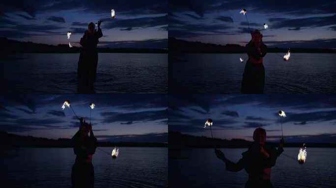 专业的女特技演员在河岸上用火表演危险的特技