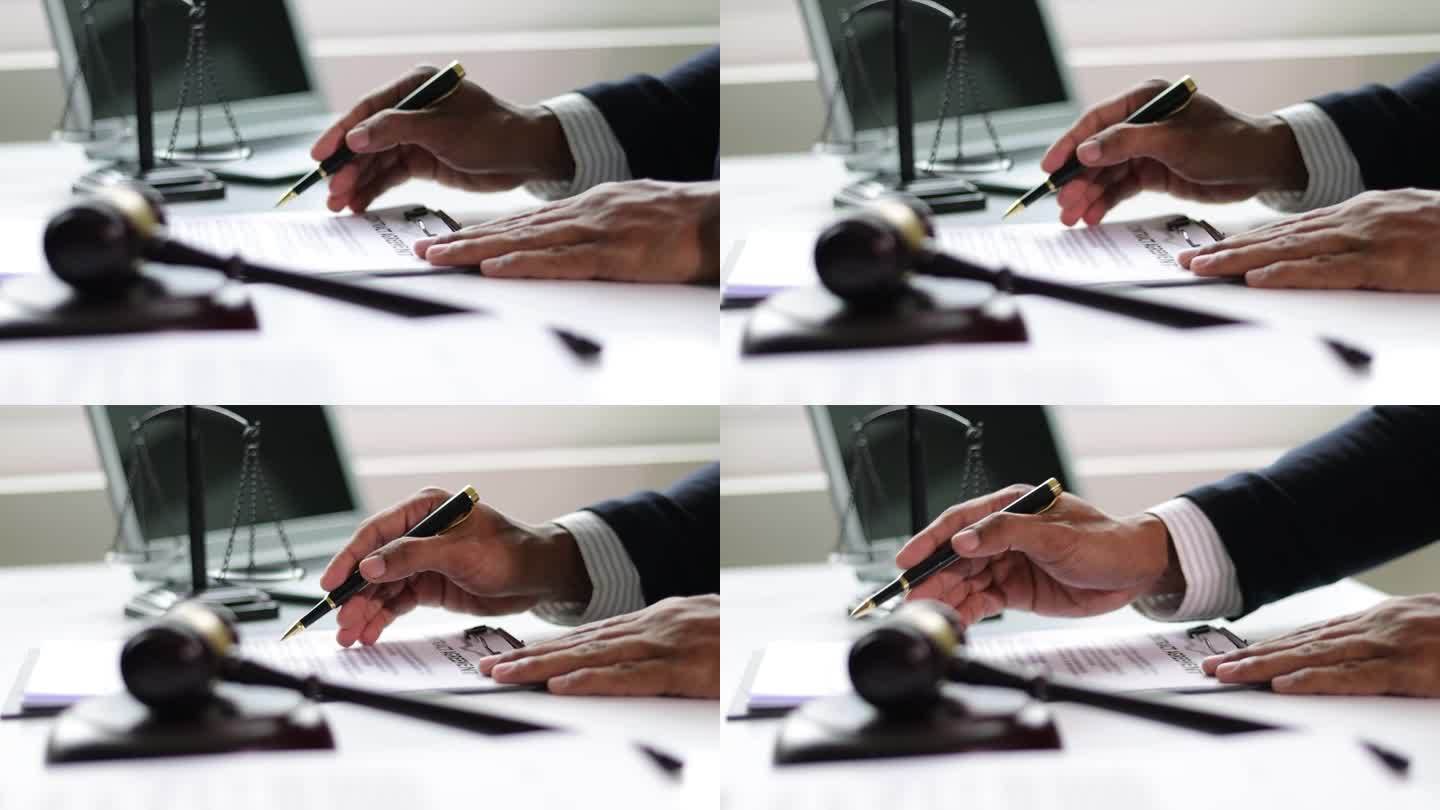 法律公正理念，律师在办公室做文书工作，阅读合同协议和签署文件。