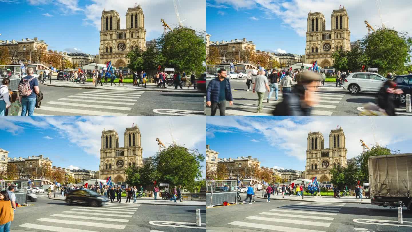 法国巴黎，夏天，游客在巴黎圣母院标志性建筑仍在重建的景点步行过马路