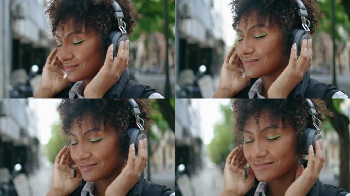 听音乐的女子无线耳机特写。非洲女孩喜欢美妙的声音。