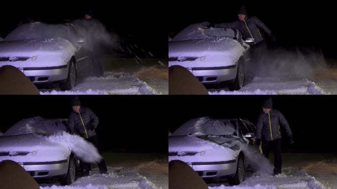 傍晚下班后，一名男子站在车道上清理车上的积雪。一个男人用长长的大刷子打扫雪