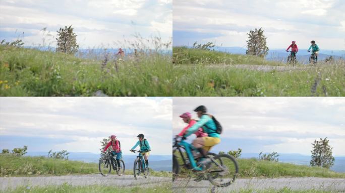 两位女性朋友骑着电动自行车沿着漂亮的山路行驶