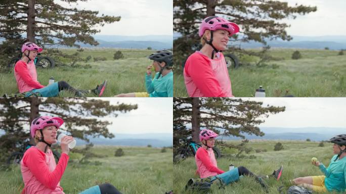两个女性朋友在山上骑山地自行车休息时聊天