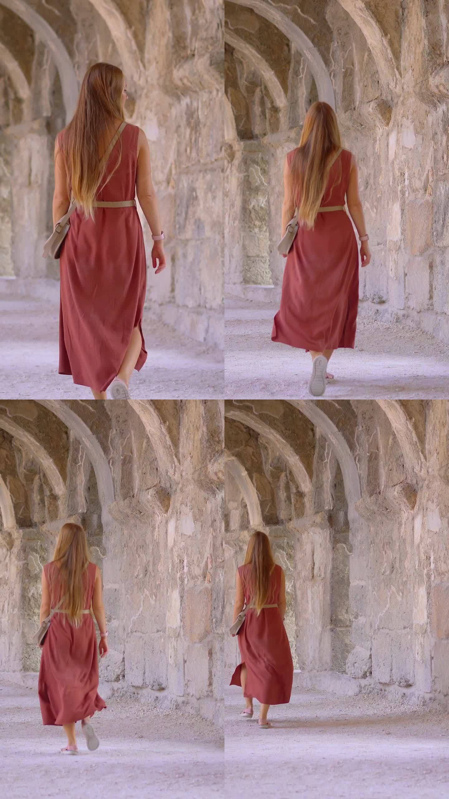 垂直视频。故事的格式。一位年轻的女游客正走在阿斯潘多斯古罗马剧院的圆柱画廊里。了解土耳其的历史。