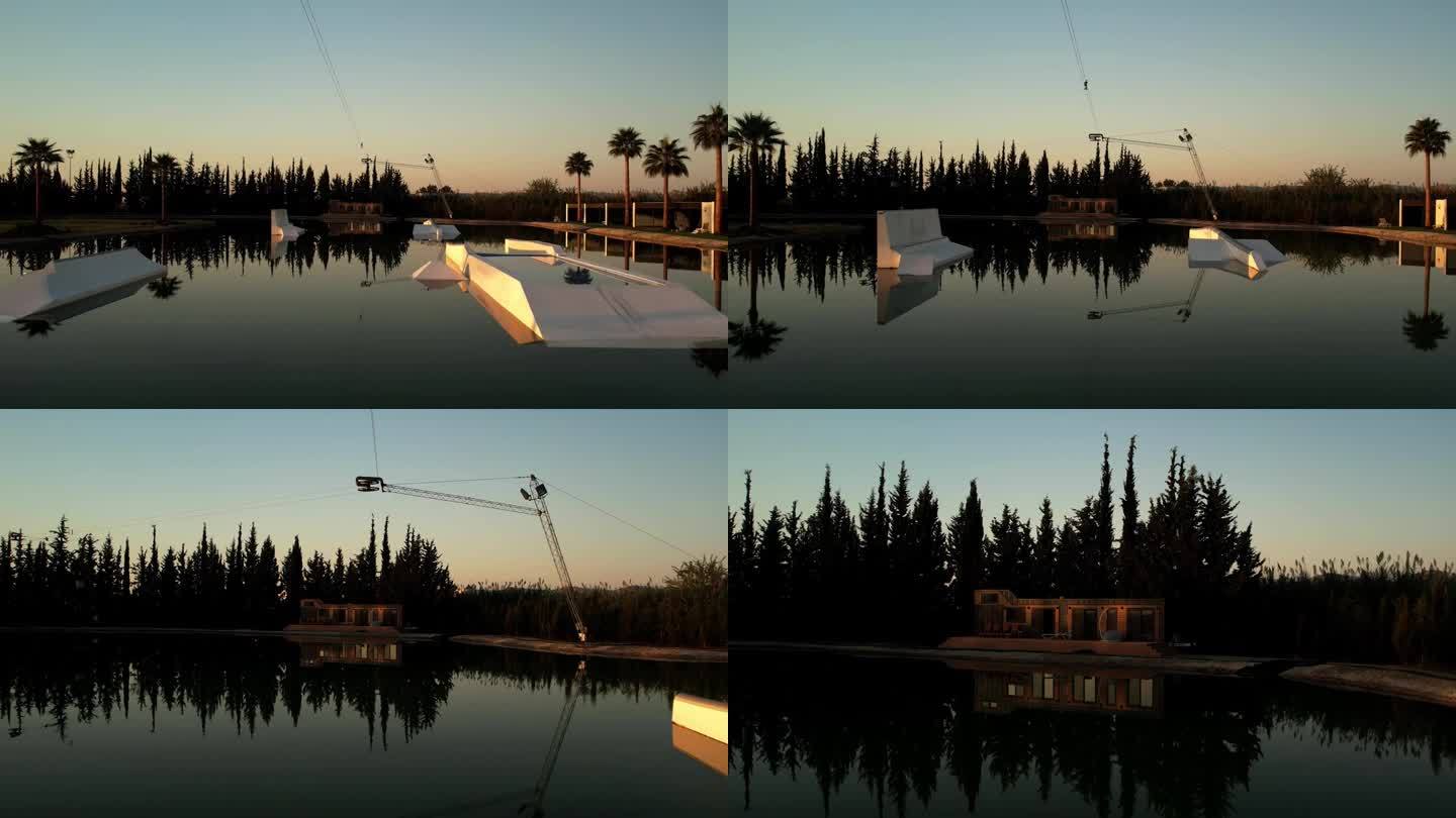 水上公园的日出。无人机在水中升起，金色的阳光美丽地反射在前景中，一棵棕榈树正在生长，没有人醒来。