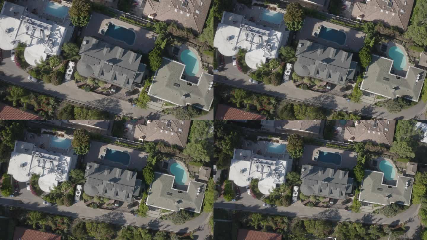 好莱坞山后院游泳池的4k无人机软木螺旋拉出镜头。