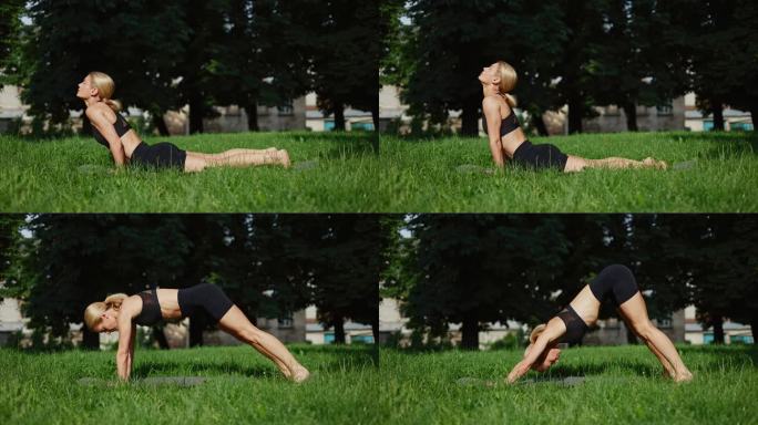 苗条的女运动员弯腰躺在公园草坪上的黑色瑜伽垫上。美丽的高加索女人在开阔的空间保持身体平衡。健康生活方