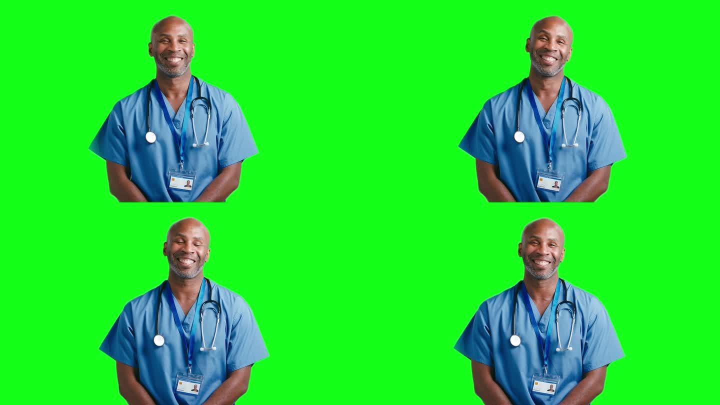 工作室肖像微笑成熟的医生或护士穿着工作服对绿屏幕