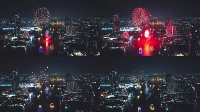 多色烟花在城市和摩天大楼上表演，庆祝夜晚的灯光、河流和曼谷大桥