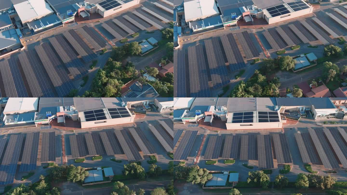 空中平移。在南非的一个购物中心，太阳能电池板提供了一个阴凉的停车场。气候变化，全球变暖，绿色可再生能