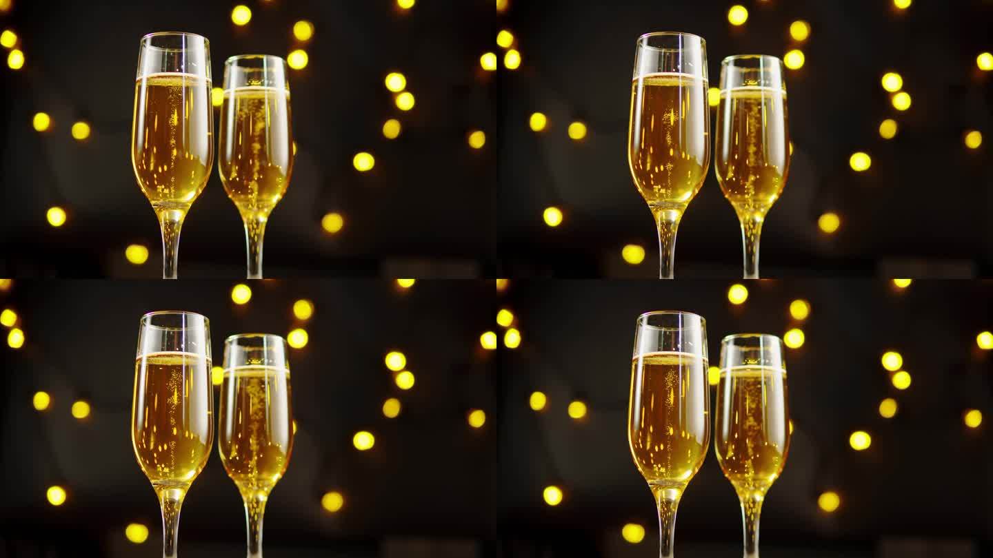 金色香槟酒杯特写，气泡酒。酒精黄金饮料黑色背景与灯光，庆祝，节日。