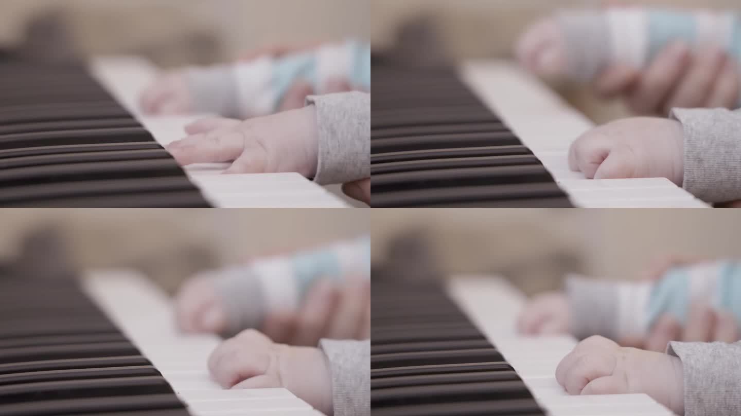 小宝宝的手在弹奏钢琴的琴键。