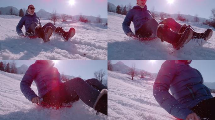 慢镜头，特写:快乐的年轻女子享受着从雪山上滑下的乐趣