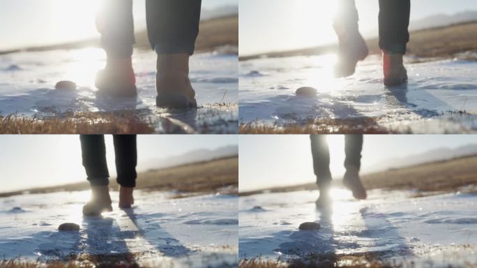 青海湖边人迎着阳光走在破碎的冰面
