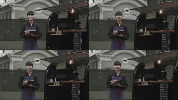 日本咖啡师在她的咖啡拖车旁的肖像