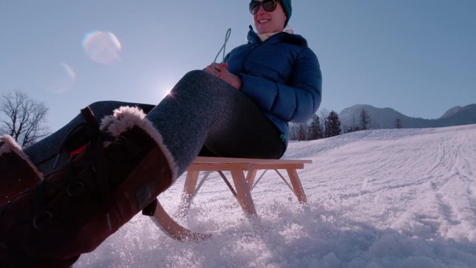 慢镜头，特写:一位美丽的女士正享受着雪橇的乐趣