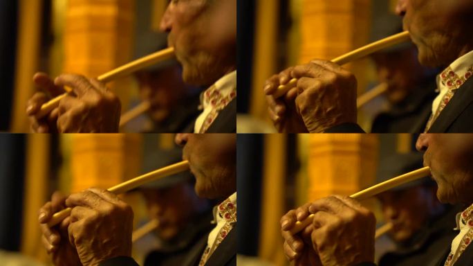 少数民族塔吉克族老人吹奏民族乐器骨笛