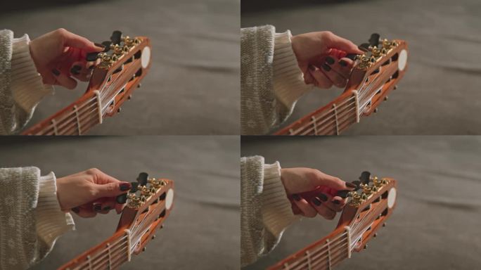 一个女人的手的特写，而调整吉他-股票视频