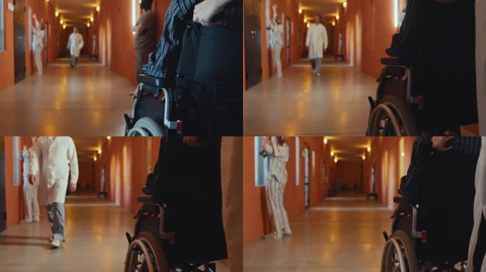 护士推着轮椅上的病人沿着走廊走