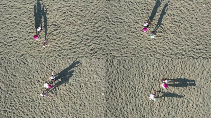 无人机拍摄的画面显示，三个戴着棒球帽的孩子在沙滩上投下长长的影子