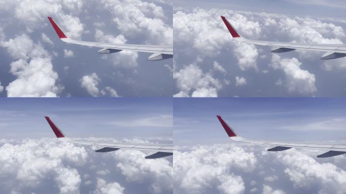 客机机上角度拍摄高空中飞行的机翼蓝天白云