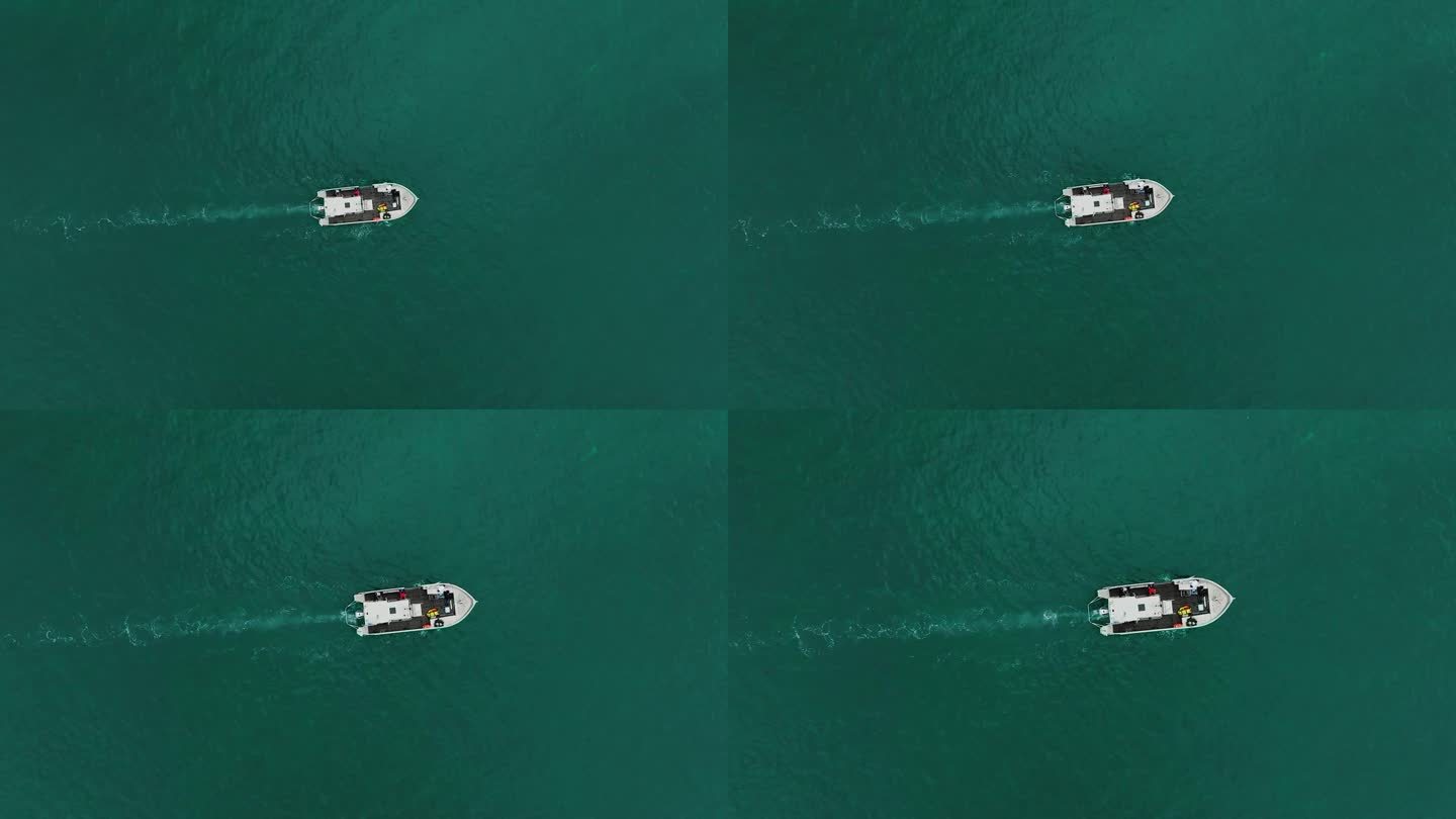 科学家们在全球变暖的考察中，俯瞰摩托艇在蓝绿色的地中海上航行。