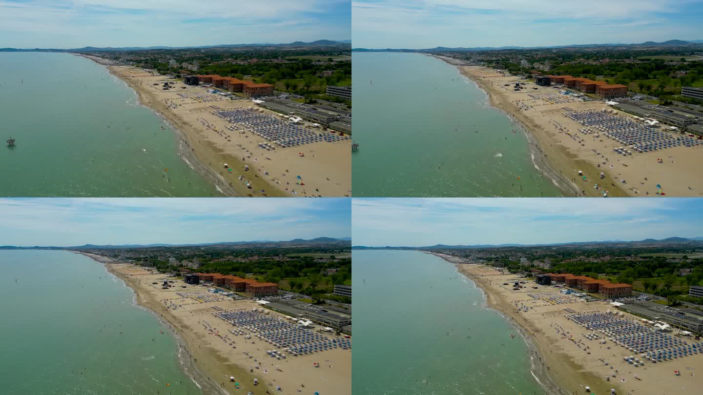 从飞行的无人机鸟瞰图人们聚集在意大利放松的海滩。暑假概念。