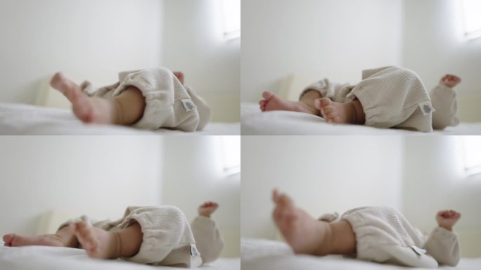 刚出生的婴儿在婴儿床里哭时，腿使劲扭动。